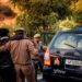French police officers assist a distressed mother and child during a crypto ransom rescue operation.