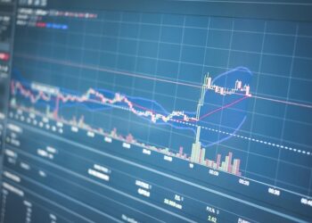 A stock market display showing Nakamoto's logo and trading statistics amidst financial graphs.