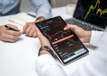 A financial professional reviewing PEPE cryptocurrency data on a digital tablet.