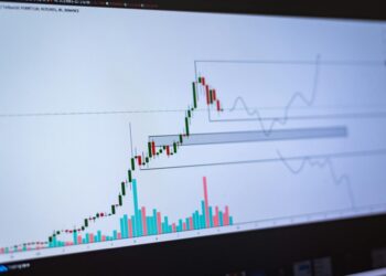 Graphs showing declining Bitcoin trading volume with concern signals in the background.