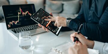 A business meeting with charts and graphs focused on cryptocurrency and finance.