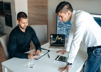 Government officials discuss cryptocurrency regulations at a conference table with digital assets displayed.