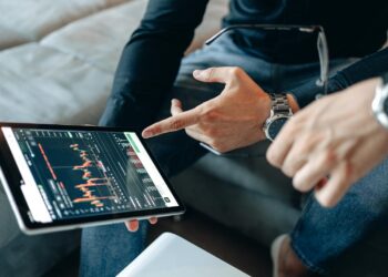 Financial professionals analyzing Bitcoin options trading on digital screens.