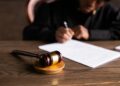 A courtroom scene with a gavel and legal documents, highlighting financial regulation issues.