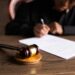A courtroom scene with legal documents and a gavel, highlighting financial regulation issues.