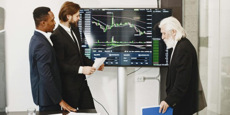 Group of diverse individuals discussing cryptocurrency trading at a financial conference.