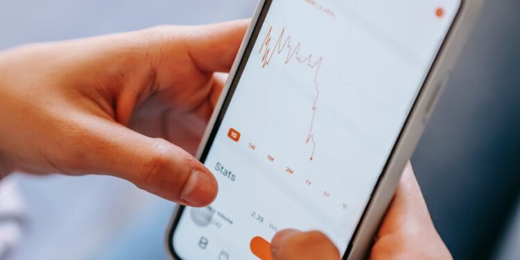 A person using a smartphone to access a cryptocurrency loan app interface.