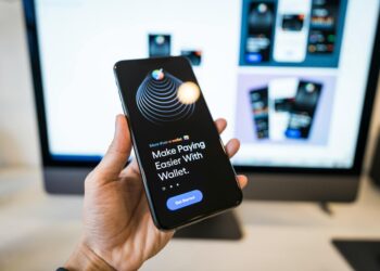 A smartphone displays a digital wallet app showing stablecoin transactions for creators.