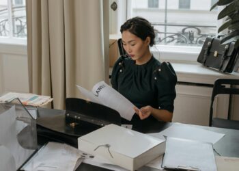 A lawyer reviews financial documents with AI integration, highlighting filing discrepancies.