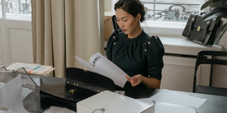 A lawyer reviews financial documents with AI integration, highlighting filing discrepancies.