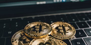 A close-up of a quantum computer with Bitcoin symbols around it, representing cryptographic threats.