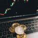Visual showing a hacker in a digital environment with cryptocurrency symbols and financial graphs.