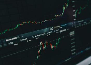 A stock market display shows significant declines in cryptocurrency values.