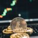 Bitcoin coins on a financial graph background, symbolizing crypto investment trends.