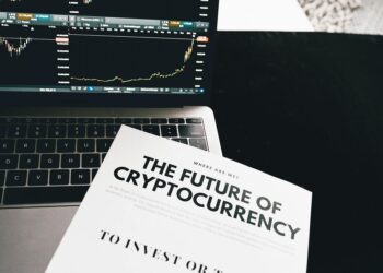 A close-up of financial documents with graphs highlighting crypto and AI investments.