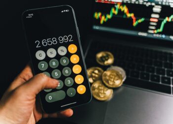 Bitcoin coins displayed with financial charts and a calculator, symbolizing debt resolution.
