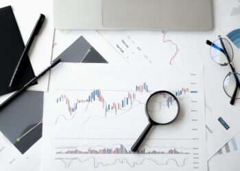 A gavel rests on financial documents, symbolizing regulatory actions in prediction markets.