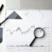 A gavel rests on financial documents, symbolizing regulatory actions in prediction markets.