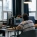 Team of engineers working on AI technology in a modern office setting with Pentagon models.