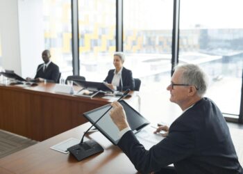 Investors discussing crypto initiatives with Vietnamese officials in a conference setting.