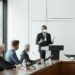 Kevin Warsh speaking at a financial conference, discussing crypto regulation.