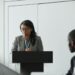 OpenAI CEO speaking at a podium about AI superintelligence regulations and risks.