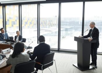 Nvidia CEO speaks at a podium, discussing AI and underreported data centers in China.