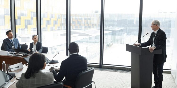 Nvidia CEO speaks at a podium, discussing AI and underreported data centers in China.