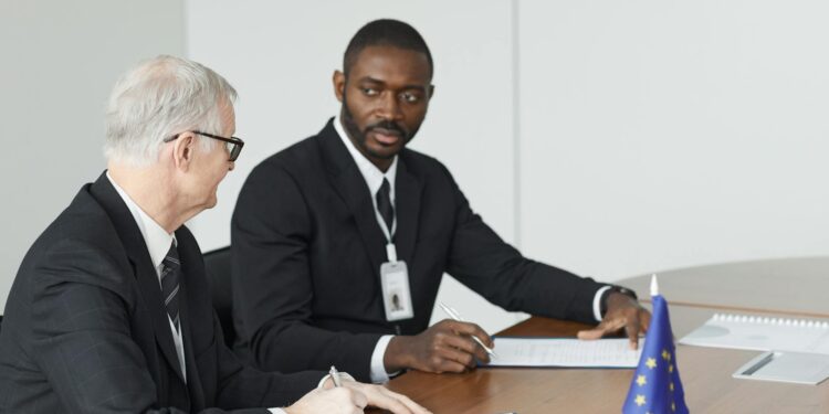 Regulatory officials discussing finance policies with Kalshi logo in background.