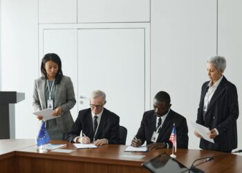 Delegates from Israel and Lebanon engage in dialogue around a conference table in Washington.