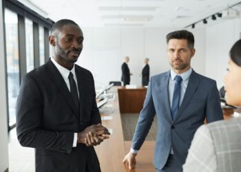 KuCoin executives discussing compliance strategies in a modern office setting.