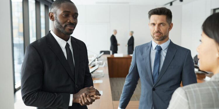 KuCoin executives discussing compliance strategies in a modern office setting.