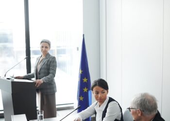 Japanese government officials discussing cryptocurrency regulations at a conference.