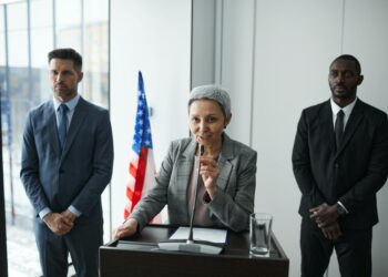 Government officials discussing cryptocurrency regulations in a conference room.