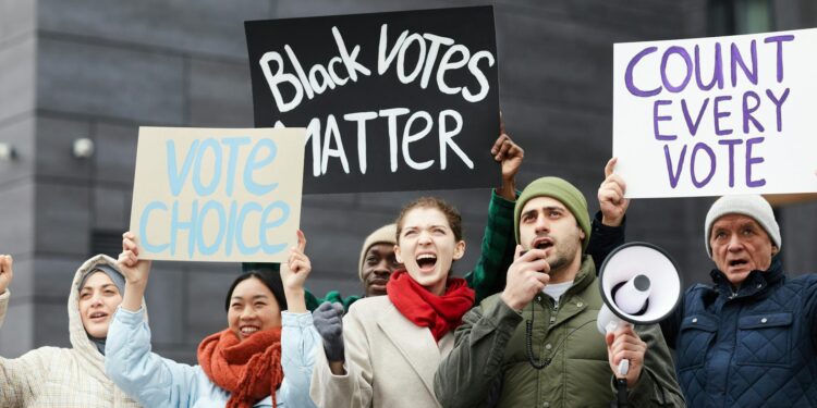 Protesters holding signs advocating for crypto regulations outside a government building.