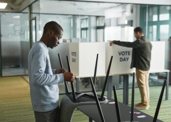 Voters at a polling station review ballots for Virginia's redistricting plan.