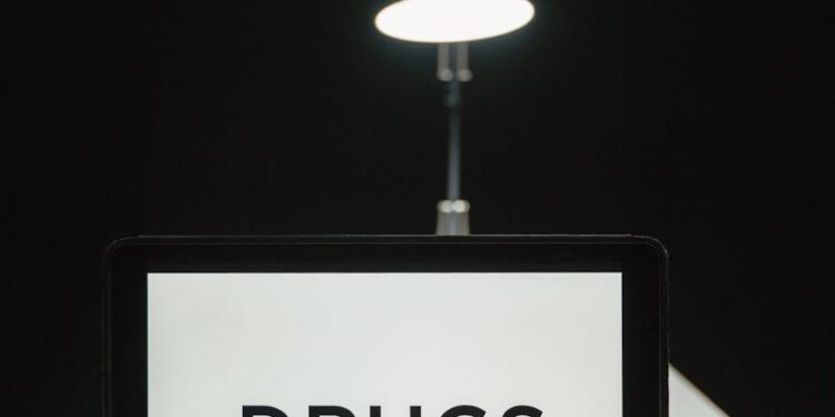 Law enforcement officers inspecting cryptocurrency trading devices during FCA raids in the UK.