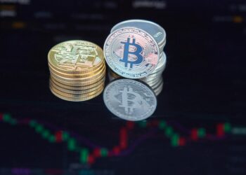 Bitcoin coins stacked with a background graph showing rising investment trends.