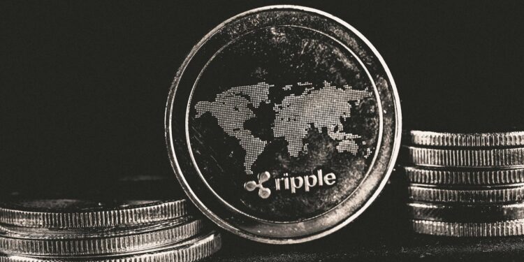 Ripple Labs logo with XRP and RLUSD tokens, representing crypto integration in finance.