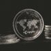 Ripple Labs logo with XRP and RLUSD tokens, representing crypto integration in finance.