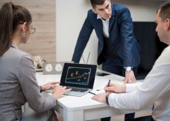 Tether executives discuss Bitcoin merger strategy at a financial conference.