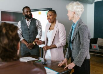 Group of investors discussing blockchain strategies in a modern office setting.