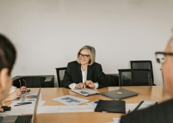 Nakamoto executives discussing strategy in a financial boardroom setting.