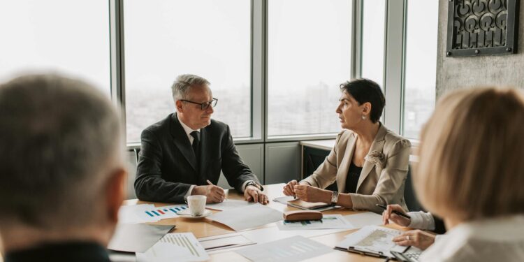 A business meeting with finance professionals discussing stablecoin regulations.