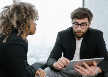 Banking professionals discussing blockchain technology in a modern financial office setting.