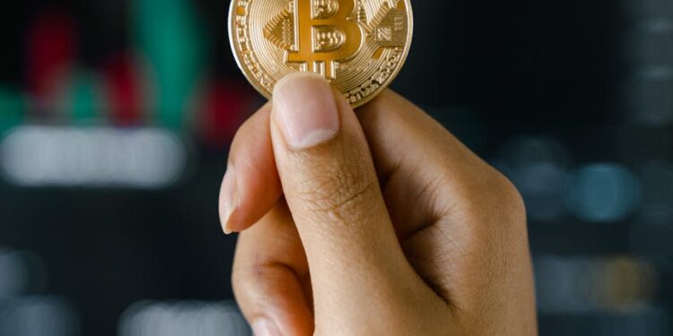 Person holding a Bitcoin Visa card amid cryptocurrency symbols and financial charts.