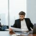 Bank executive reviewing cybersecurity reports with cybersecurity icons in the background.