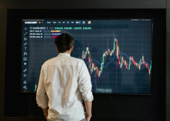 A financial analyst reviewing cryptocurrency trends on a digital interface.