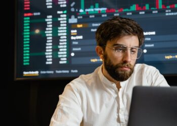 A digital illustration of a job seeker analyzing blockchain data on a computer screen.