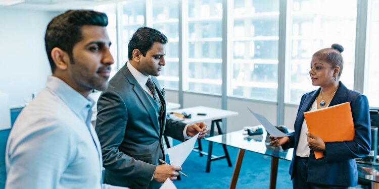 Coinbase executives discussing regulatory approval in a modern office setting.